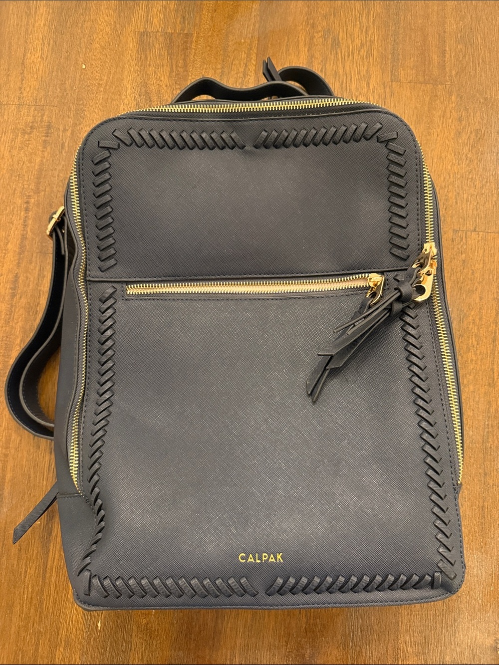 Calpak Black Leather Backpack with Gold Zippers and Woven Trim